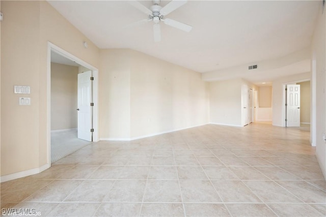 empty room with ceiling fan and light tile patterned floors