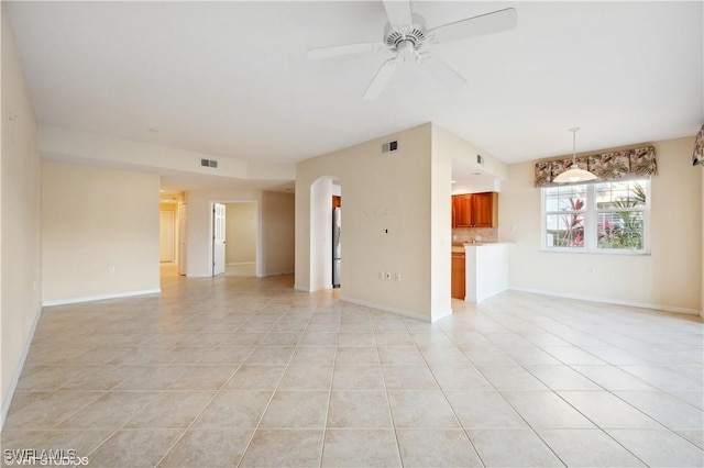 unfurnished living room featuring ceiling fan and light tile patterned floors