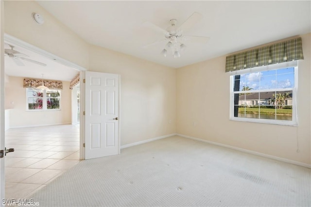 unfurnished room featuring ceiling fan and light tile patterned floors