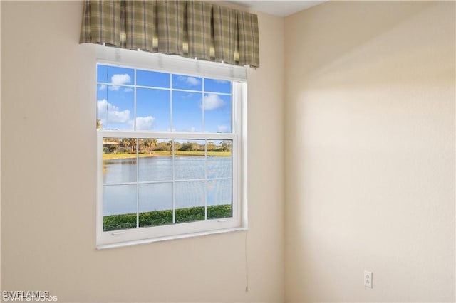 empty room with a wealth of natural light and a water view