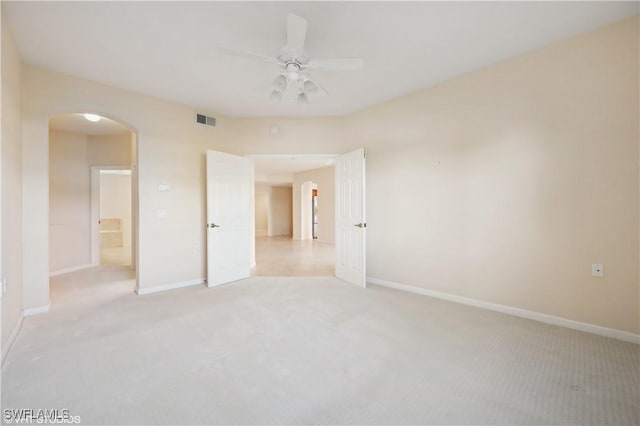 carpeted spare room featuring ceiling fan