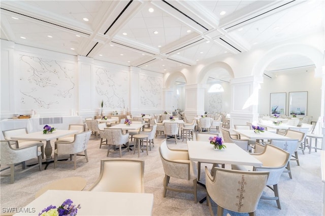 dining space featuring beamed ceiling and coffered ceiling