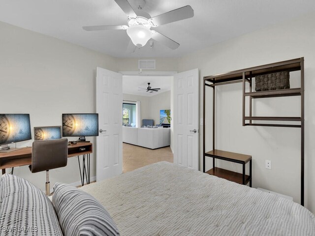 tiled bedroom featuring ceiling fan