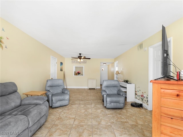 living room featuring light tile patterned floors and ceiling fan