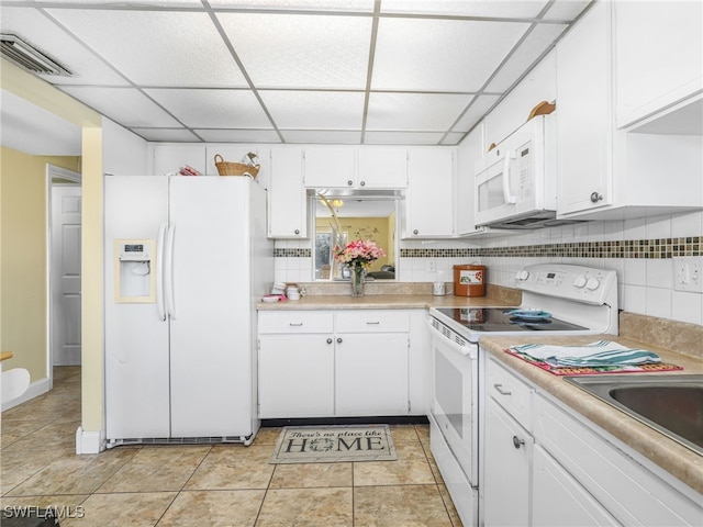 kitchen with white cabinets, decorative backsplash, white appliances, and a paneled ceiling