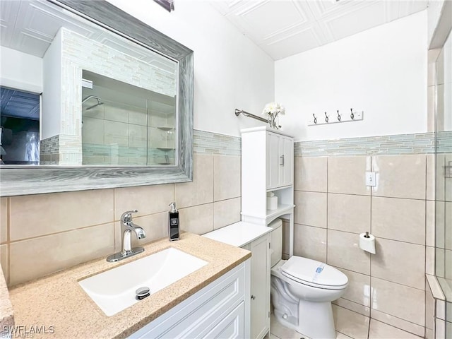 bathroom with walk in shower, vanity, toilet, and tile walls