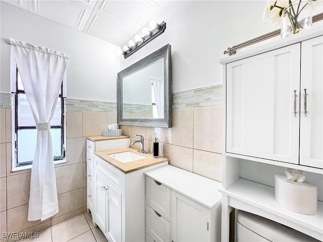 bathroom featuring tile patterned floors, vanity, and tile walls