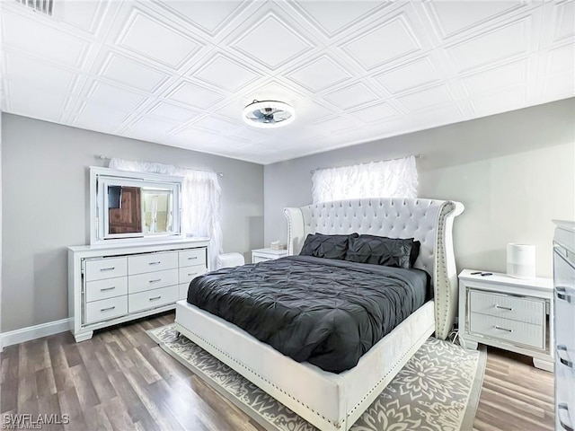 bedroom with dark hardwood / wood-style flooring