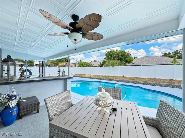 view of swimming pool featuring an outdoor bar and ceiling fan