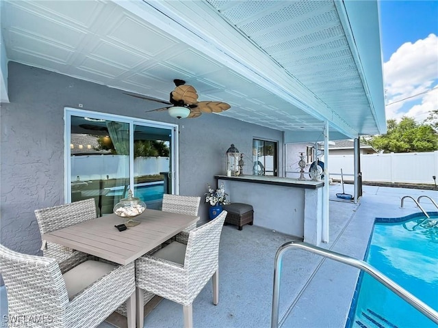 view of patio with a fenced in pool, an outdoor bar, and ceiling fan