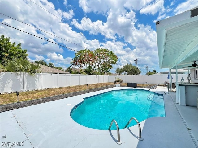 view of swimming pool featuring ceiling fan and a patio area