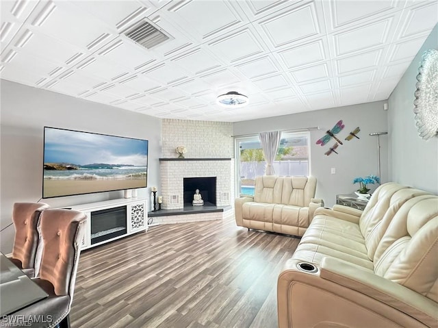 living room with hardwood / wood-style floors and a fireplace