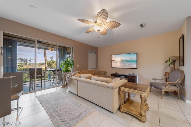 living room with ceiling fan and light tile patterned flooring