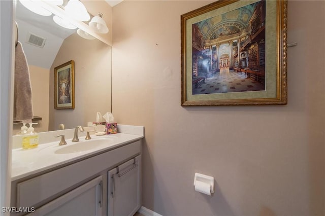 bathroom featuring vanity and lofted ceiling