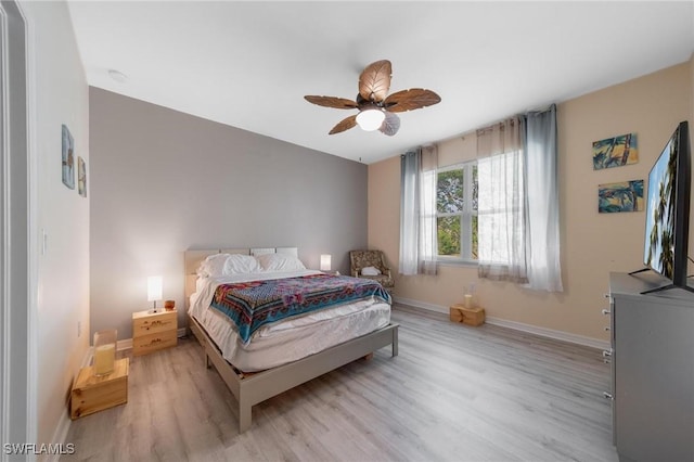 bedroom with ceiling fan and light hardwood / wood-style flooring