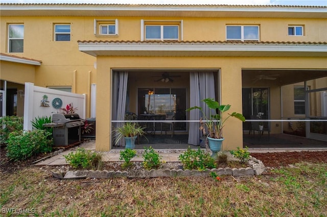 rear view of property with a sunroom