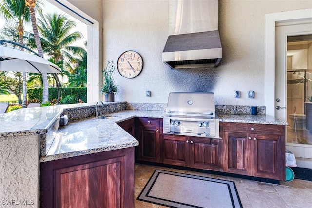 view of patio featuring a wet bar, an outdoor kitchen, and a grill