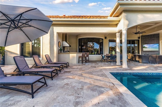 exterior space with ceiling fan, a patio, exterior bar, and an outdoor hangout area