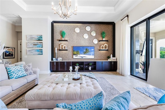 living room with crown molding, an inviting chandelier, and a tray ceiling