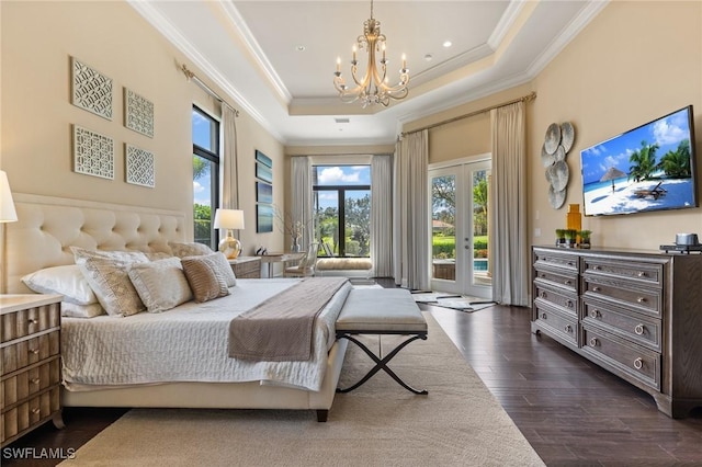 bedroom with french doors, access to outside, dark wood-type flooring, a tray ceiling, and a notable chandelier