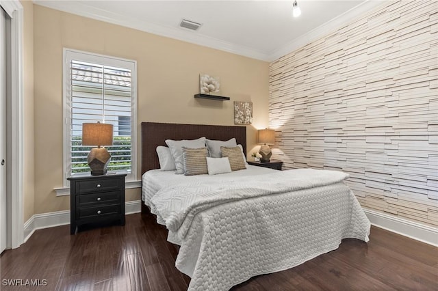 bedroom featuring multiple windows, dark hardwood / wood-style floors, and ornamental molding