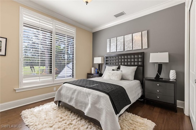 bedroom with dark hardwood / wood-style floors and ornamental molding