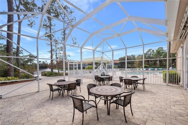 view of patio with glass enclosure