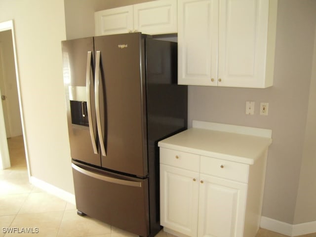 kitchen with white cabinetry, stainless steel fridge with ice dispenser, and light tile patterned flooring