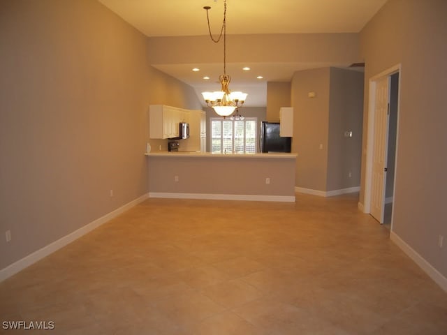 unfurnished living room featuring an inviting chandelier