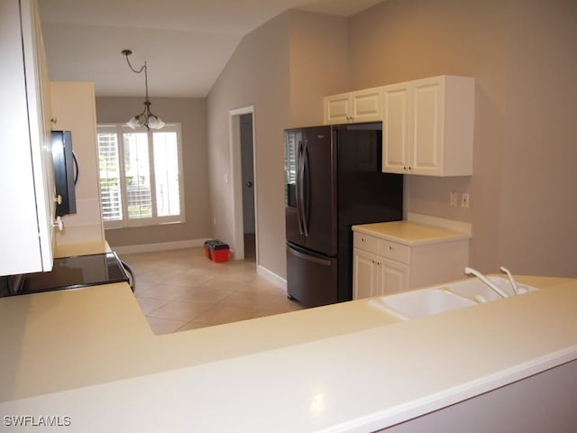 kitchen featuring white cabinetry, light tile patterned floors, decorative light fixtures, and a notable chandelier