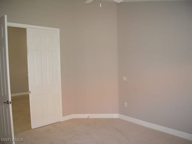 unfurnished room with ceiling fan and light colored carpet