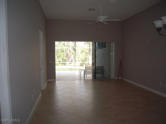 tiled spare room with ceiling fan