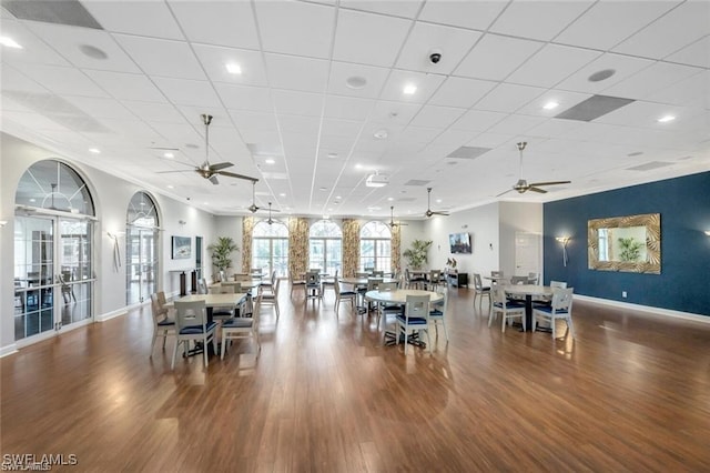 dining space with hardwood / wood-style floors and ceiling fan