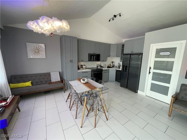 tiled dining area featuring lofted ceiling