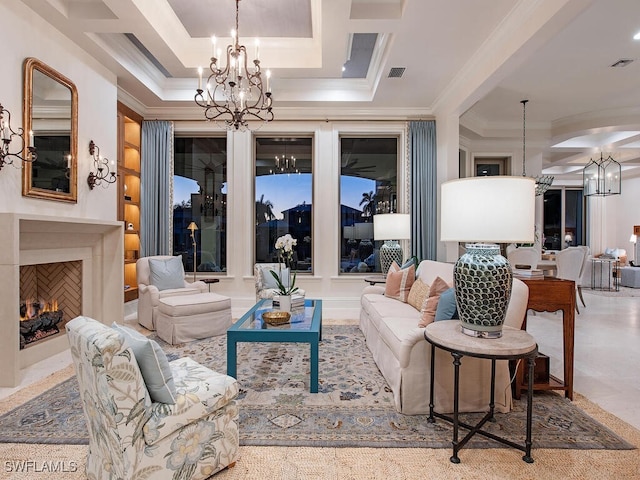 living room featuring visible vents, an inviting chandelier, ornamental molding, and a fireplace