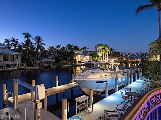 dock area featuring boat lift and a water view