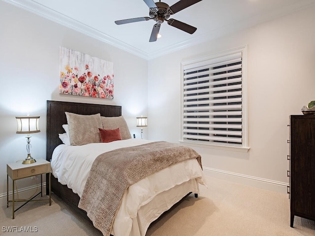 bedroom featuring carpet flooring, baseboards, ceiling fan, and crown molding