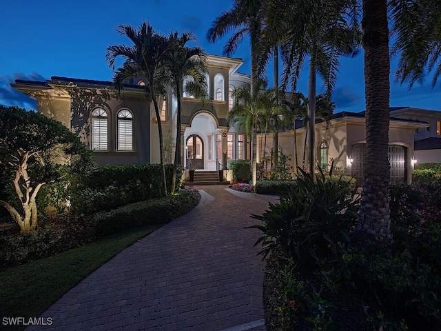 mediterranean / spanish home featuring stucco siding