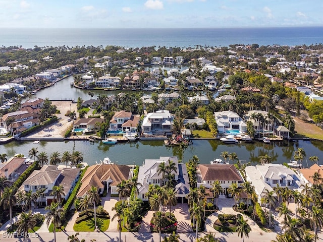 drone / aerial view featuring a water view and a residential view