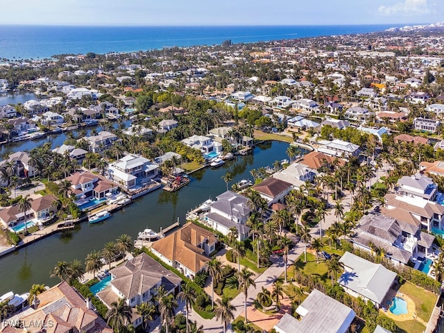 birds eye view of property with a water view and a residential view