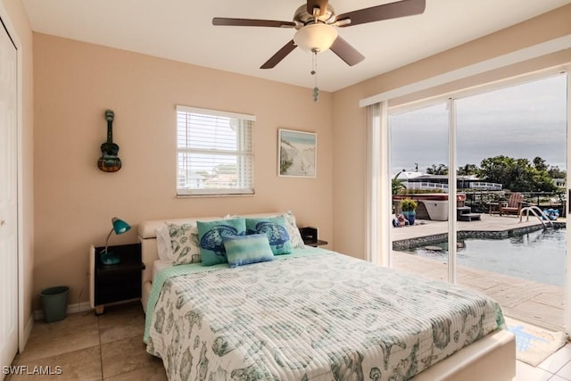 bedroom with light tile patterned floors, ceiling fan, and access to outside