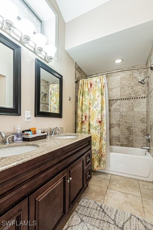 bathroom featuring shower / bathtub combination with curtain and vanity