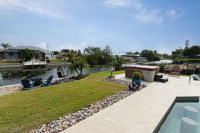 view of yard featuring a patio area, a hot tub, and a water view