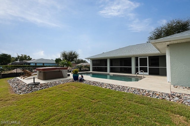 view of swimming pool with a sunroom, a patio area, a lawn, and a hot tub