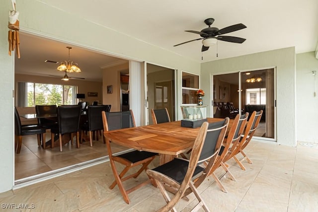 dining area with ceiling fan with notable chandelier