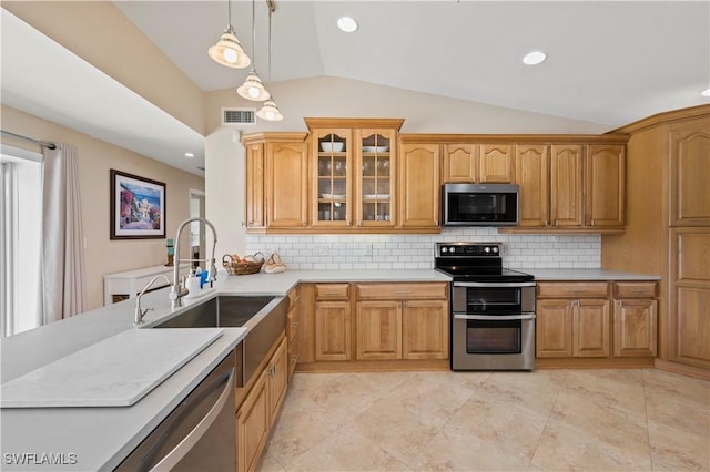 kitchen with pendant lighting, stainless steel appliances, lofted ceiling, backsplash, and sink