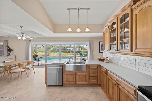 kitchen featuring sink, dishwasher, ceiling fan, track lighting, and pendant lighting