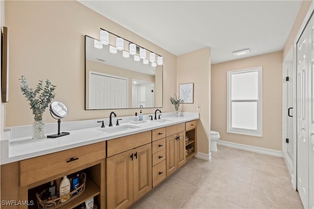 bathroom featuring toilet, vanity, tile patterned flooring, and walk in shower