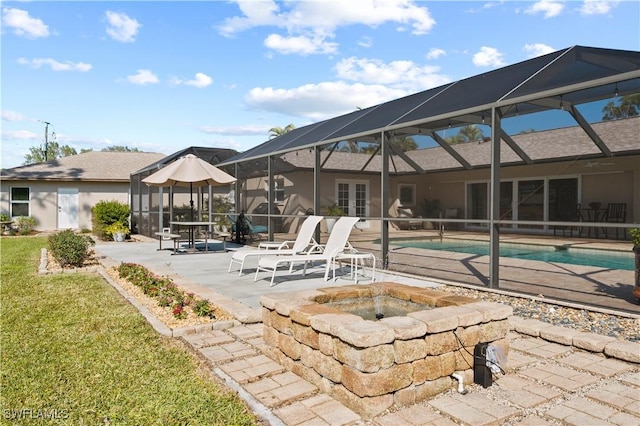 exterior space with an outdoor fire pit and a lanai