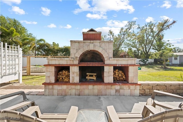 view of patio with a fireplace